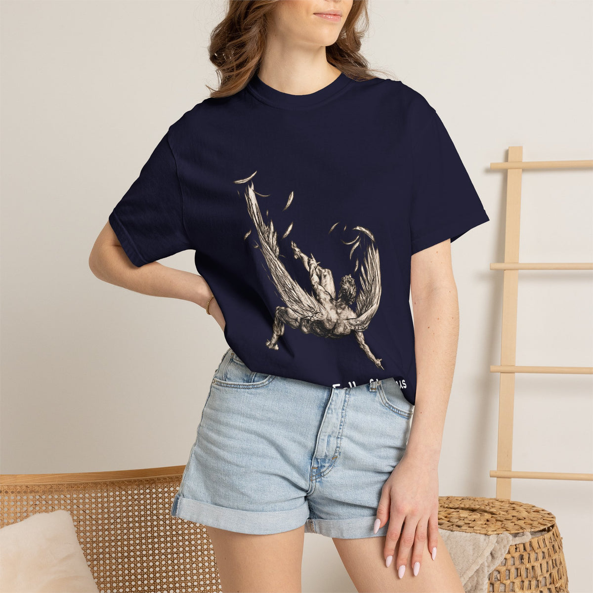 Fall of Icarus Greek mythology T-shirt in Ivory, worn on a Mediterranean street at golden hour — falling winged figure