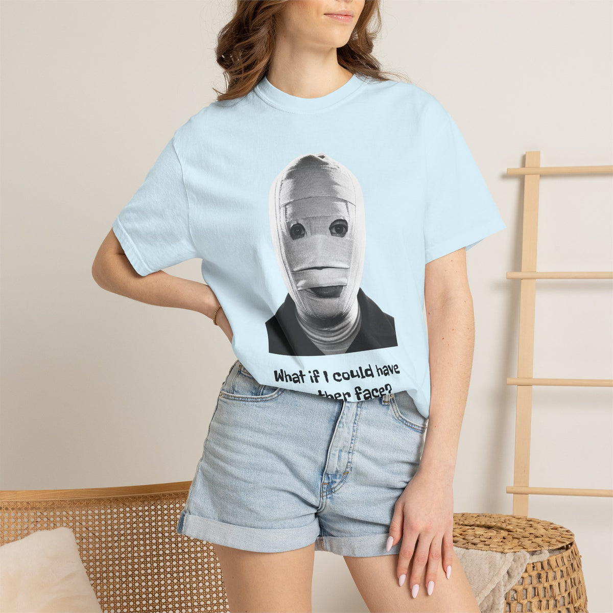 The Face of Another literary T-shirt with a bandaged mask and existential question on a garment-dyed unisex T-shirt, product view