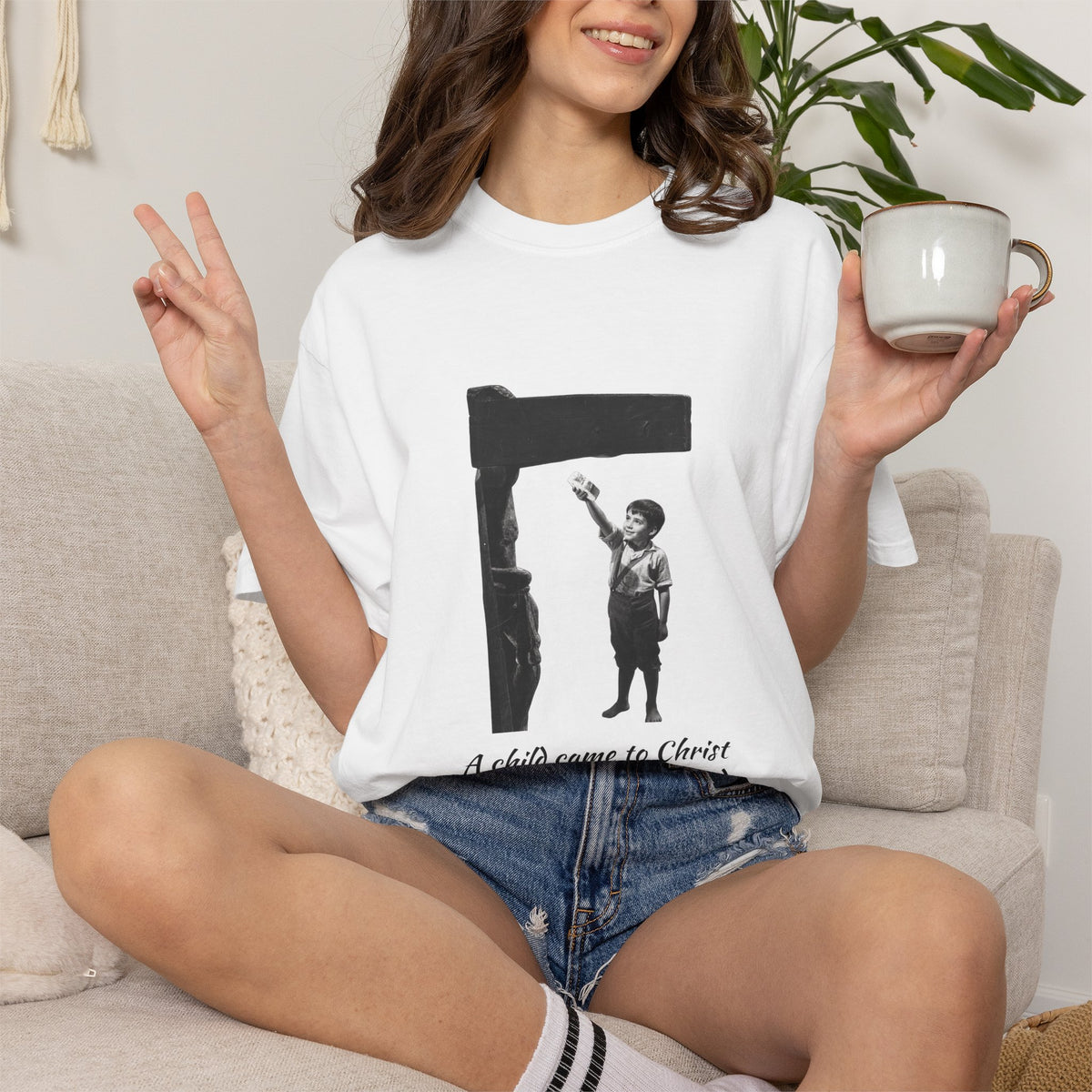 Marcelino Bread and Wine T-shirt in White on a model sitting on a sofa