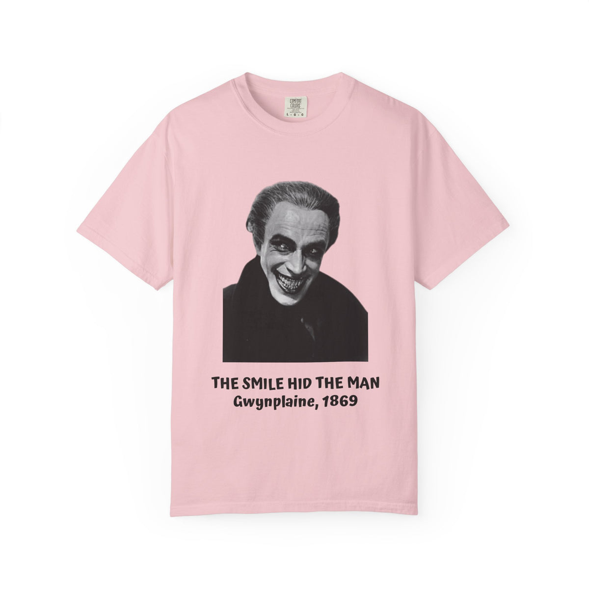 The Man Who Laughs Gwynplaine T-shirt in Chambray blue, worn outside a bookshop — 'The Smile Hid the Man, Gwynplaine 1869'