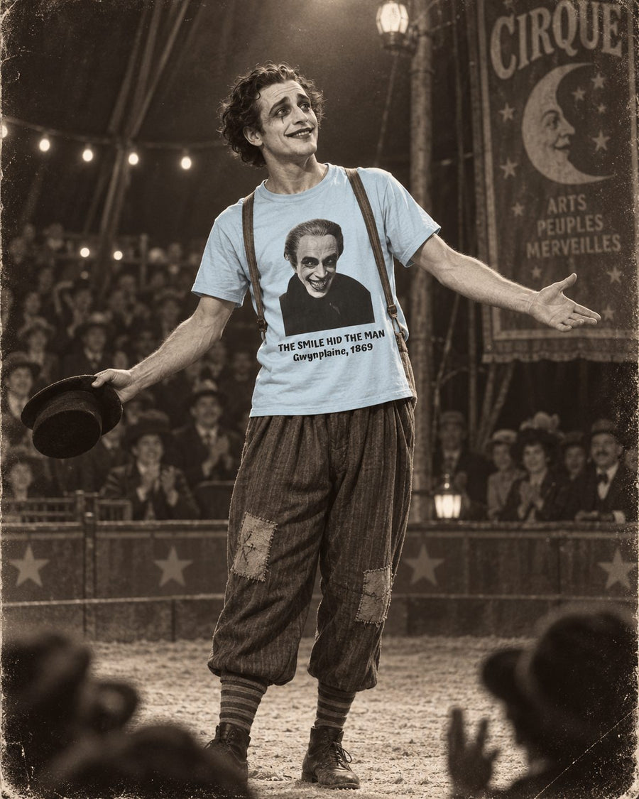Sepia photograph of a performer taking a bow in a crowded circus ring, hat in hand, wearing a shirt printed with a carved permanent grin and the words: the smile hid the man, Gwynplaine, 1869.